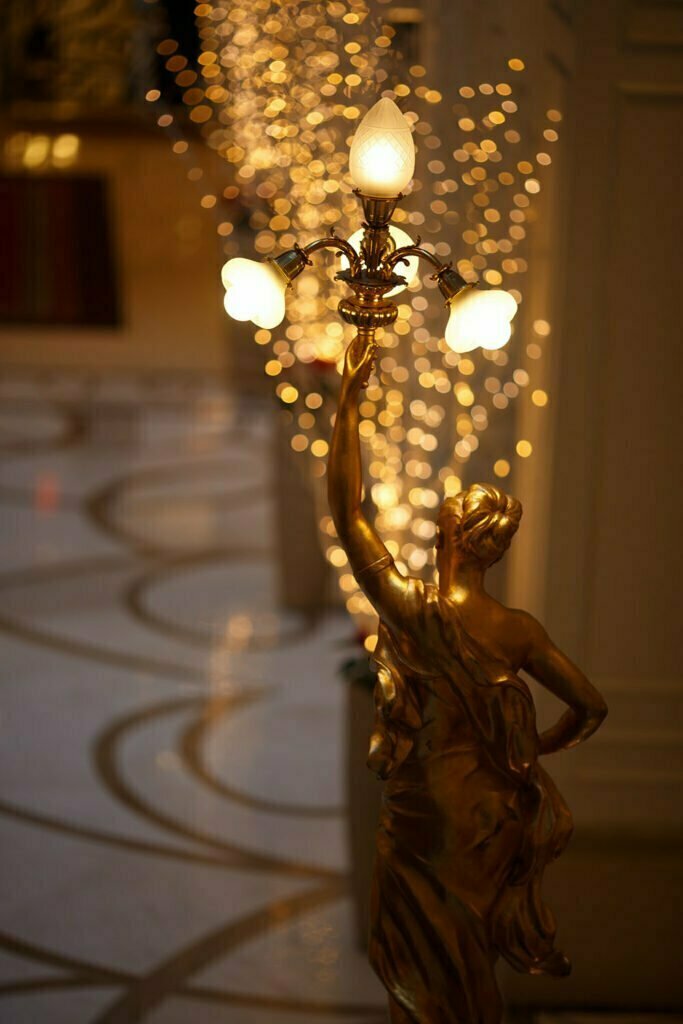 Statue holding lamp lights